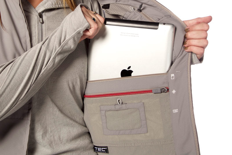 Female model demonstrating the iPad pocket of the ScotteVest RFID blocking jacket