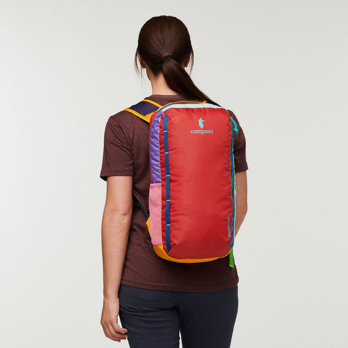 Back perspective of a woman carrying the Cotopaxi Batac backpack