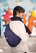 Man modeling the AmeriBag Healthy Back Bag against an urban background