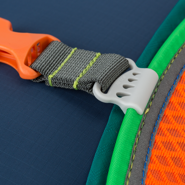 Zoomed-in detail of the Cotopaxi Batac backpack's blue and orange section with a green strap