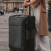 Person holding a Samsonite D'Lite Large Expandable Spinner suitcase