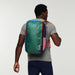 Rear view of a person wearing the Cotopaxi Batac backpack with a multicolored pattern