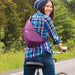 A woman carrying the AmeriBag Healthy Back Bag Microfibre X-Small while riding a bicycle