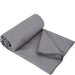 Anti-bacterial travel towel neatly folded, showcasing its grey color
