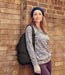 Lifestyle shot of a person leaning against a wall while wearing the AmeriBag Healthy Back Bag