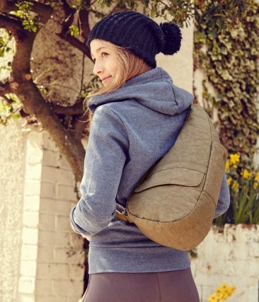 Individual modeling the AmeriBag Healthy Back Bag accessorized with a hat