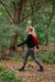 Hiker carrying the AmeriBag Healthy Back Bag through a wooded trail