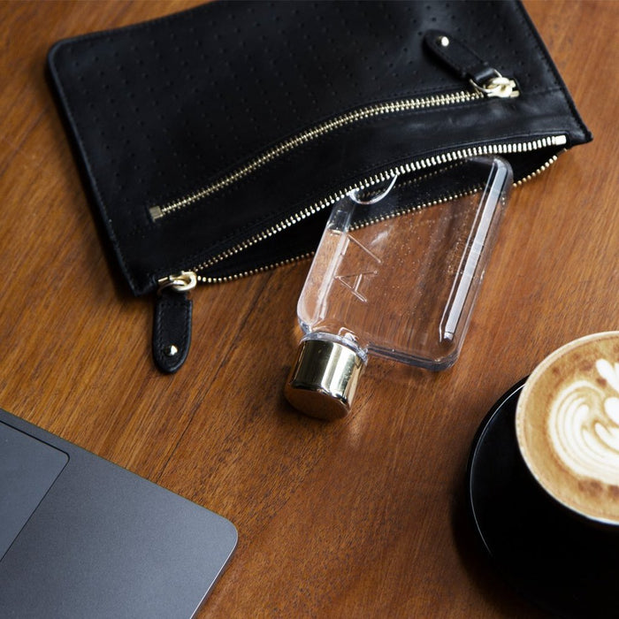 A7 Memobottle 180ml Flat Water Bottle next to a laptop and coffee cup