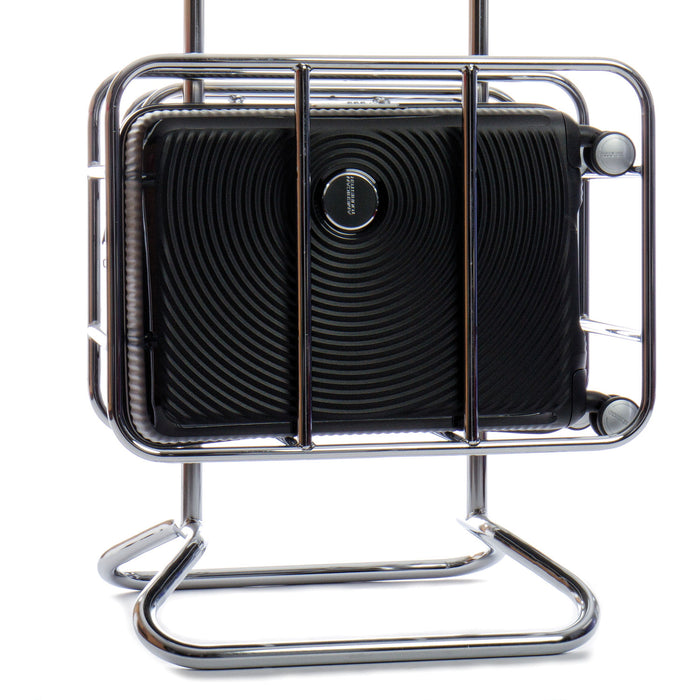 American Tourister Curio carry-on spinner displayed on a metal luggage stand