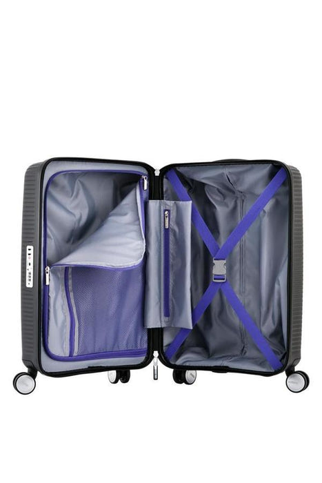 American Tourister Curio carry-on spinner featuring black and purple design on white
