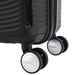 Rear view of the American Tourister Curio black carry-on spinner against a white setting