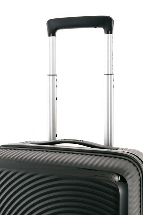 Side view of the American Tourister Curio black carry-on spinner on white