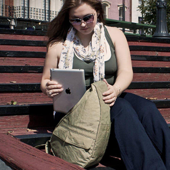 Lifestyle image of a woman relaxing on steps with her AmeriBag Healthy Back Bag