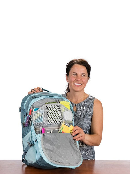Happy woman showcasing the Osprey Celeste backpack