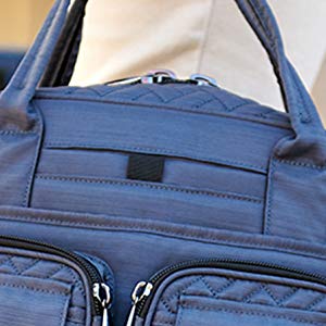 Blue Lug Mini Puddle Jumper held by a woman, showcasing the zipper details