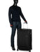 Display of Samsonite D'Lite Large Spinner suitcase with a mannequin in a coat