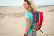 Female hiker carrying a Cotopaxi Batac 16L backpack outdoors